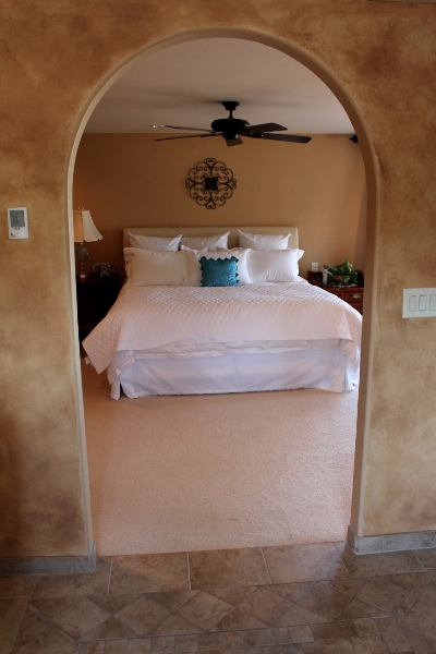 Arched entryway into master bedroom